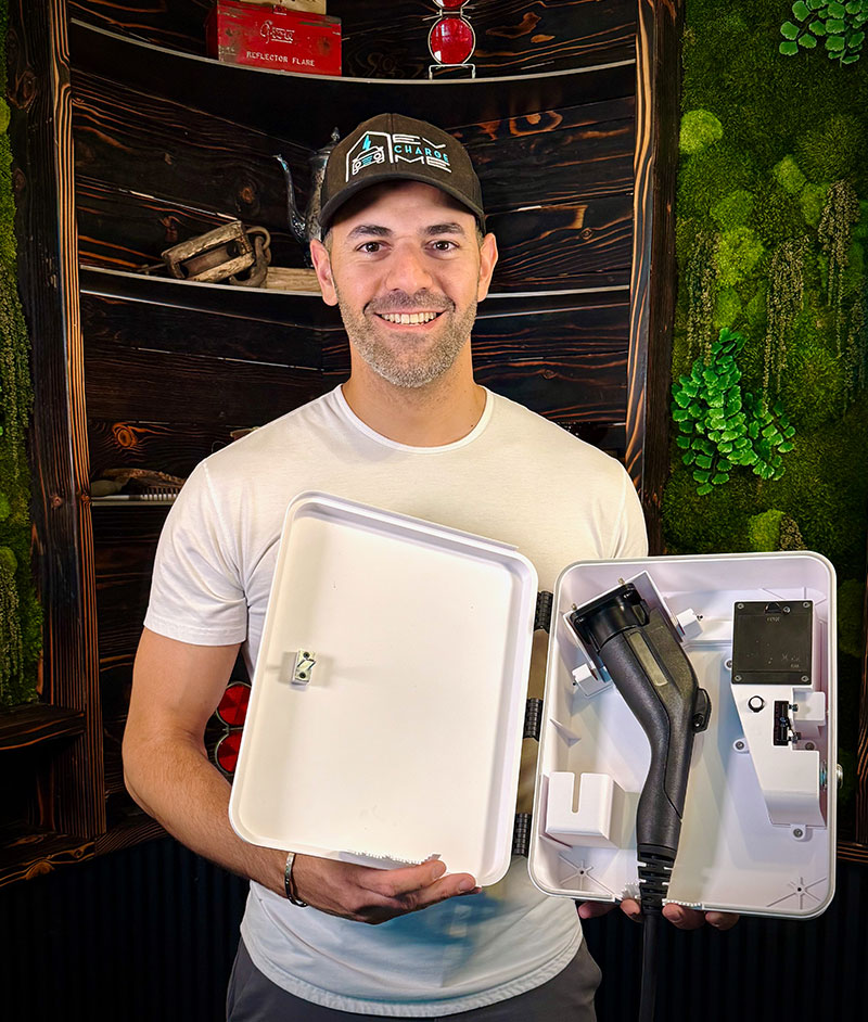 Sam Syed, Co-Founder & CEO of EVchargeME - holding a prototype box

